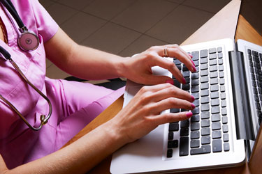 A nurse on a laptop