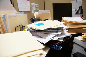 A desk with a pile of papers